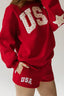 Red sweatshirt and shorts with 'USA' text on a plain background