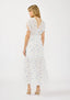 Woman wearing a white floral dress on a white background