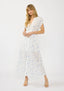 Woman wearing a white floral dress on a white background