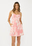 Woman wearing a pink floral dress on a white background