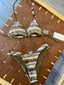 Gold and brown striped bikini set on a brown surface with a tag.