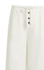 White pants with button details on a white background
