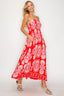Woman wearing a red floral dress on a white background