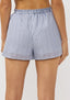Blue and white striped shorts worn by a person on a light gray background