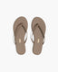 Pair of beige flip-flops on a white background