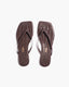 Pair of brown flip-flops with a textured pattern 