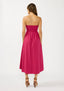 Woman wearing a pink strapless dress on a white background