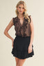 Woman wearing a brown ruffled top and black skirt on a beige background