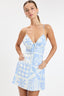 Woman wearing a blue and white patterned dress on a white background
