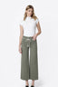 A woman modeling a pair of olive green wide-leg cropped pants with a cream drawstring waist, paired with a white mock-neck short-sleeve top, against a plain white studio background.