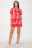 Woman wearing a red and white patterned outfit on a white background