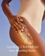Person applying luxurious ultra-rich butter to their skin with a clear blue sky background
