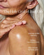 Person applying body oil to shoulder with text highlighting benefits