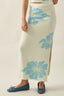 midi skirt—the soft cream base, pale blue florals, and relaxed knit feel give it a breezy seaside aesthetic: