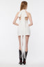 Woman wearing a white dress with a long bow and black boots on a white background
