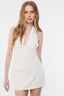 Woman wearing a white dress against a plain background