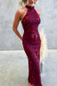 Burgundy evening gown with floral lace details on a neutral background