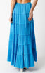Blue tiered skirt worn by a person on a white background