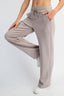 Person wearing beige sweatpants on a white background