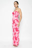 Woman wearing a pink floral strapless gown on a white background