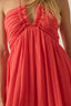 Red dress with thin straps on a blurred background
