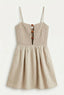 Beige smocked dress with thin straps on a white background