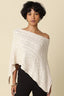 Woman wearing a white lace shawl against a beige background