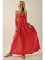 Woman wearing a red dress on a plain background