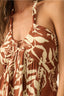 Close-up of a brown and beige patterned top worn by a person.