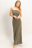 Woman wearing a green strapless dress on a white background