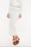 Woman wearing a white off-shoulder top and skirt set on a white background