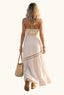 Woman in a coastal beige halter cut out maxi dress