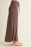 Brown wide-leg pants with a drawstring waist on a beige background