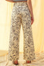 Person wearing floral-patterned pants with a soft, blurred background