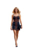 A woman walking in a European-style town square wearing a navy blue mini dress with orange geometric trim, holding a small navy clutch.