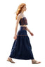 A woman walking outdoors in a navy blue two-piece set featuring a cropped camisole top and a matching maxi skirt with geometric embroidery.