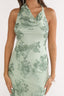 Green floral dress worn by a person on a white background