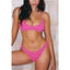 Woman wearing a pink bikini against a tiled wall background