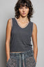 Woman wearing a patterned sleeveless top against a plain background