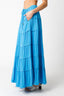 Blue tiered maxi skirt worn by a person on a white background