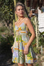 Woman wearing a colorful patterned dress in an outdoor setting