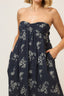 Navy strapless dress with floral pattern worn by a person on a beige background