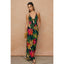 Woman wearing a colorful floral dress against a beige background