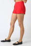 Person wearing red shorts on a white background