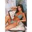 Woman in a green bikini sitting on a floral chair with decorative wallpaper.