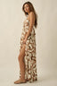 Woman wearing a patterned dress on a beige background