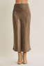Brown satin skirt worn by a person on a beige background
