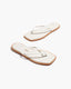 Pair of white flip-flops with beige soles 