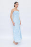 Woman wearing a light blue strapless dress with sequin details on a white background