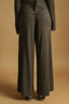 Dark gray suit with wide-leg pants on a beige background